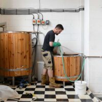 Husk Brewing, brewing in progress in a large wooden tank